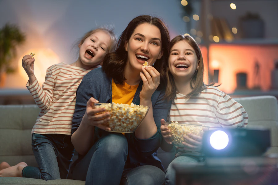 A family sharing popcorn during a movie night at home